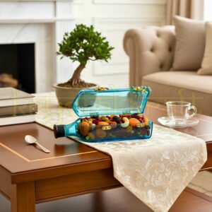"Upcycled Bombay Sapphire glass canister by Krystal Kraft filled with dry fruits on kitchen counter"
